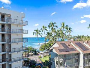 a view of the ocean from the balcony of a building at Kolu Honu - Stunning Beachfront Condo for 2 in Kailua-Kona