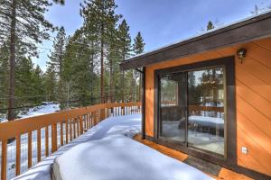 a cabin with a large window on a snowy deck at Tahoe Forest Chalet 3BR House with AC in Stateline +61 photos