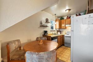 a kitchen with a wooden table and a refrigerator at Valley View - Carson Valley Views in Stateline +18 photos