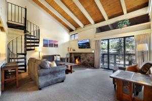 a living room with a couch and a fireplace at Lakeland Sandy Beach Retreat - Private Escape in South Lake Tahoe