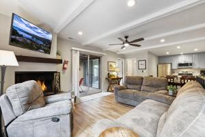 a living room with two couches and a fireplace at Family Fun Getaway - 3 Story Condo in Zephyr Cove