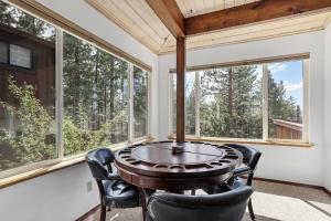 a room with a table and chairs in front of windows at Hall Court Manor - Hot tub Pet Friendly Pool Table in Stateline