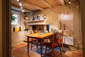 a dining room with a wooden table and chairs at Le erbe magiche in Collepardo