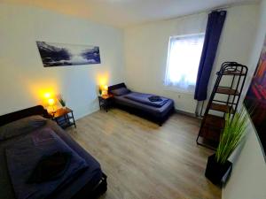 a living room with a couch and a chair at Schwert City Loft S63 in Verden