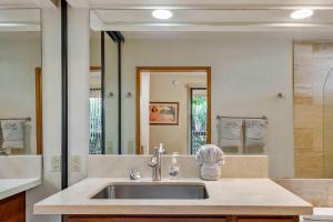 a bathroom with a sink and a mirror at Romantic Studio in Waikoloa Beach Resort in Waikoloa +9 photos