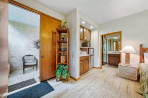 a room with a bed and a kitchen with a table at Romantic Studio in Waikoloa Beach Resort in Waikoloa