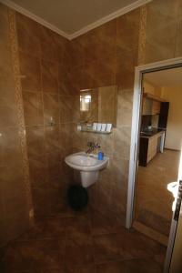 a bathroom with a white sink in a room at Hotel Marant in Sozopol