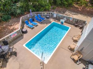 an overhead view of a swimming pool with lounge chairs at 2130 - Luna Blu Cottage in Sea Hawk