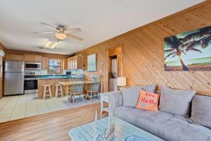 a living room with a couch and a kitchen at 7145 - Geri's Place #6 Flip Flop in Wanchese +48 photos