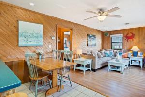 a living room with a table and a couch at 7145 - Geri's Place #6 Flip Flop in Wanchese