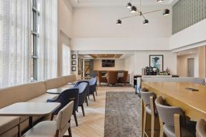 a waiting room at a hospital with tables and chairs at Staybridge Suites Sacramento Woodland by IHG in Woodland