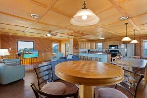 a dining room and kitchen with a table and chairs at 7143 - Geri's Place #4 in Wanchese