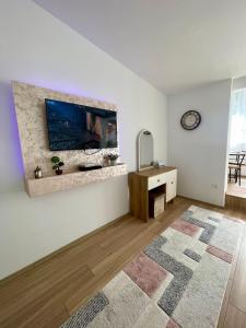 a living room with a tv on a wall at Lina Apartment Prizren in Prizren
