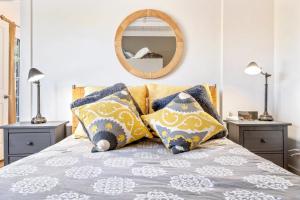 a bedroom with a bed with pillows and a mirror at New Short distance to Ocean in Wells