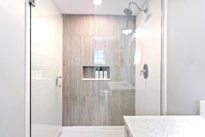 a bathroom with a shower with a glass door at New Short distance to Ocean in Wells