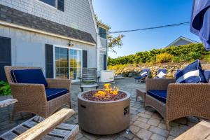 a patio with chairs and a fire pit at New Short distance to Ocean in Wells