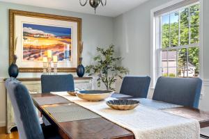 a dining room with a wooden table and chairs at Maine Adventure 3BR Oasis Awaits in York