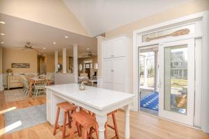 a kitchen and living room with a table and chairs at Stunning 5 BDR Walk to York Harbor Beach in York +37 photos