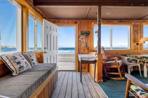 a room with a bed and a view of the ocean at Beachfront Pet Friendly Sleeps 15 and BBQ in York