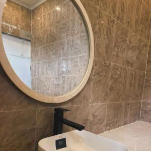 a bathroom with a mirror and a sink at HS Villas in Zanzibar City +5 photos