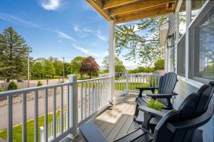 a porch with two chairs and a table at Large Family Retreat Near Beach Private Decks in Wells