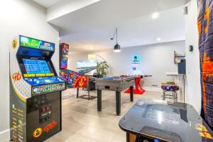 a room with a video game system and a table at In-Home Arcade Hot Tub Golf Close to Beach in Old Orchard Beach