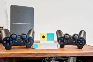 two video game controllers sitting on a table at Games Gym Equipment Projector Family Focused in Wells