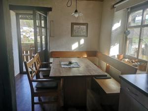 a kitchen with a table and chairs in a room at Ferienhaus Aschoff in Mauchen