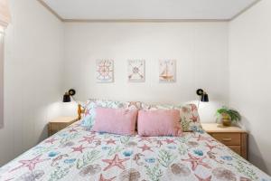 a bedroom with a bed with two pink pillows at 5206 - Hogg Heaven in Croatan Shores