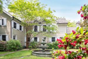 a home with a fountain in the yard at Summerset Villa by Rove - Family Home with Pool & Hot Tub in Bridgehampton
