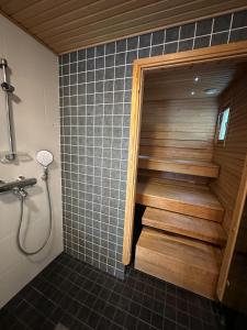 a bathroom with a shower and a staircase in a room at Virpiniemen Maston Villa, Oulu in Oulu