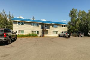 a house with cars parked in front of it at Steps to Chena River - Condo Near Hiking and Tours! in Fairbanks