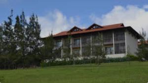 a large building with a green field in front of it at Flat Monte Castelo Gravatá - Pe in Gravatá