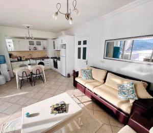 a living room with a couch and a table at olumpus Apartman Kalkan in Kaş