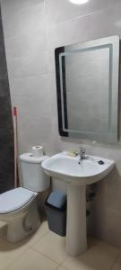 a bathroom with a toilet and a sink and a mirror at PISO En NADOR MARRUECOS in Nador