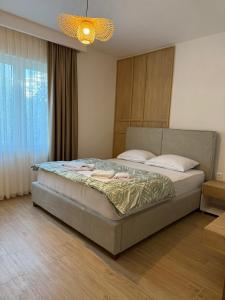 a bedroom with a large bed with a light at Villa Firenze in Ulcinj +25 photos