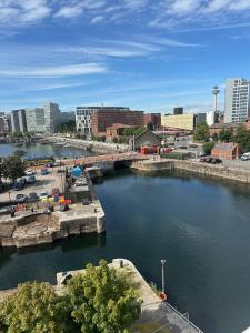 a river with a bridge in a city at Liverpool City Centre Apartment with view in Liverpool