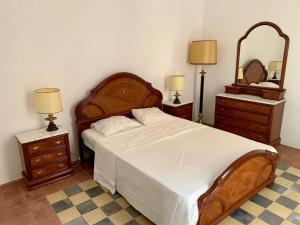 a bedroom with a large bed and two night stands at Casa l'àvia - Sant Pol de Mar in San Pol de Mar