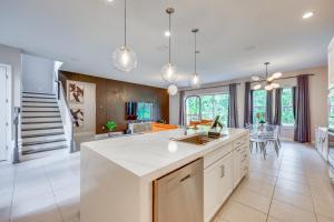an open kitchen with white countertops and a dining room at Less Than 20 Mi to JAX Beach and Game Days Upscale Retreat in Pine Bluff