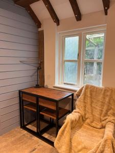 a room with a table and a chair and a window at The Hidcote Hideaway, Cotswolds in Mickleton