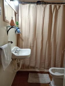 a bathroom with a sink and a shower curtain at Hogar en el corazón de Tilcara in Tilcara +7 photos