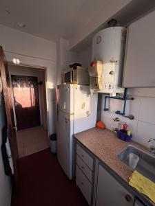 a kitchen with a white refrigerator and a sink at Departamento céntrico in Mar del Plata