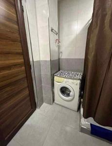 a small bathroom with a washing machine in it at bakuriani in Itʼkhvisi +1 photo