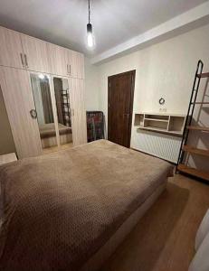 a bedroom with a large bed and a ladder at bakuriani in Itʼkhvisi