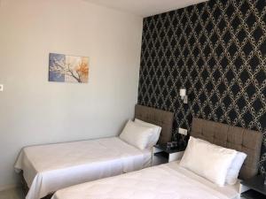 a room with two beds and a picture on the wall at GOLD SARAY PANSİYOn in Saray