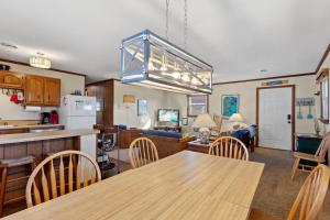 a kitchen and dining room with a table and chairs at 5165 - Holden Inn in Croatan Shores