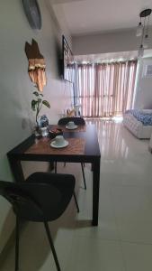 a table and a chair in a living room at Juvycondo in Davao City