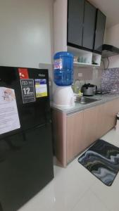 a kitchen with a mixer next to a sink at Juvycondo in Davao City