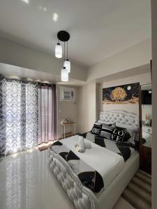 a bedroom with a large bed in a room at Juvycondo in Davao City