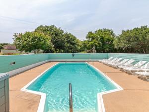a swimming pool on a roof with chairs at 2150 - A Spotted Duck in Duck